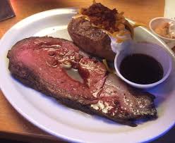 Sunny's Steakhouse signature dishes The 16oz Prime Rib, a 10oz Filet Mignon, and classic sides like the Wedge Salad and Creamed Spinach.